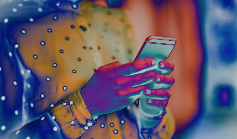 Stylized high-contrast image of hands holding a phone in blue and orange tones, suggesting digital technology and public communication